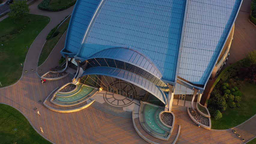 Aerial top view of a building with blue roof in modernistic architecture style. Olympic sports complex in Odessa, Ukraine.