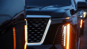Luxury black SUV convoy driving through city streets at night with LED headlights illuminated. Vehicles appear as part of a formal security escort or wedding procession. Modern cars of protection - Powered by Shutterstock - Get 15% off with code: PIKWIZARD15