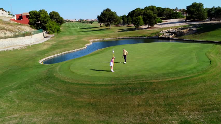 Skilled golfers carefully putting on pristine green, navigating picturesque golf course landscape with strategic precision and focused concentration - Powered by Shutterstock - Get 15% off with code: PIKWIZARD15