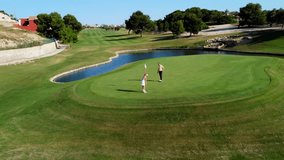 Skilled golfers carefully putting on pristine green, navigating picturesque golf course landscape with strategic precision and focused concentration - Powered by Shutterstock - Get 15% off with code: PIKWIZARD15