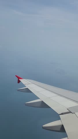 Airplane wing, flying over Asia