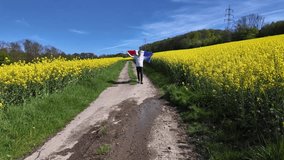 Man with French Flag in Blooming Canola Field.. - Powered by Shutterstock - Get 15% off with code: PIKWIZARD15