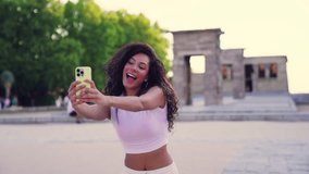 Young woman taking selfies with smartphone in front of temple of debod, an ancient egyptian temple, in madrid, spain - Powered by Shutterstock - Get 15% off with code: PIKWIZARD15