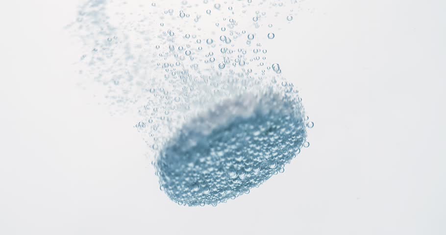 Extreme Close-up effervescent tablet, pill bubbling underwater. Shot on super slow motion camera 1000 fps.