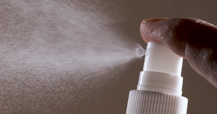 Liquid spraying fountain in a super slow motion of vaporized liquids particles. Shot on super slow motion camera 1600 fps. Spraying perfume.