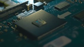 Lines of program code moves on a processor in a circuit board, symbolizing the operation of an electronic device. Closeup. Macro. Follow focus. Shallow depth of field - Powered by Shutterstock - Get 15% off with code: PIKWIZARD15