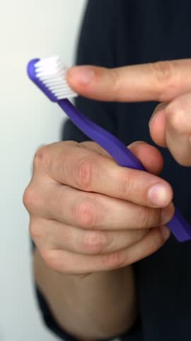 Close-up of a soft toothbrush in a person's hands.
Dental and oral health care.
Brushing teeth with a special toothbrush