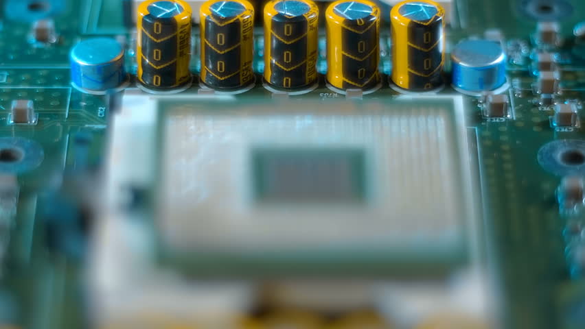 Powerful modern server computer motherboard with inverted processor where a lot of conductive legs (contacts, pins) are visible. Closeup. Macro. Follow focus. Shot in motion