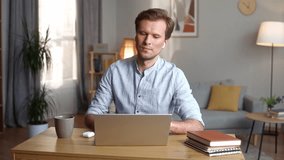 Young man wears wireless headphones, starting work on laptop at home checking email sending message making order in online store mature businessman freelancer working on internet - Powered by Shutterstock - Get 15% off with code: PIKWIZARD15