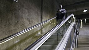 Businessman using smartphone on escalator in subway station - Powered by Shutterstock - Get 15% off with code: PIKWIZARD15