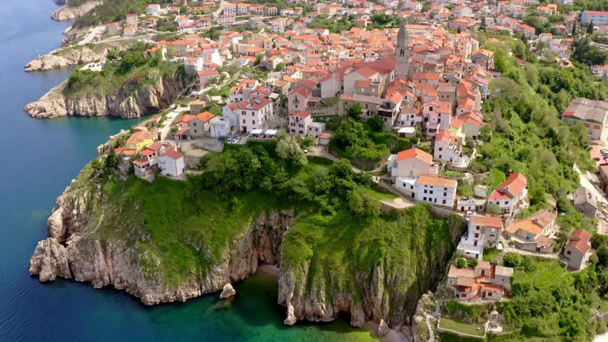 Aerial view of the picturesque town of Vrbnik on Krk Island, Croatia, with its charming stone houses, narrow streets, and stunning coastline surrounded by the blue Adriatic Sea.
