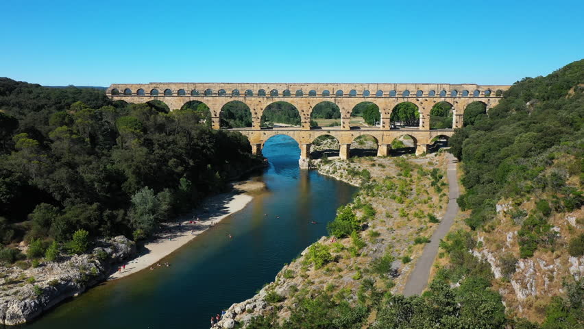 The Pont du Gard is an ancient Roman aqueduct, that is depicted  on five euro note. Summertime.