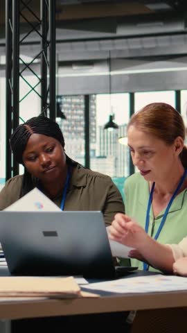 Vertical Video Confident powerful women gathering in the boardroom to evaluate data reports, establishing project goals and company metrics. Empowerment and high level decision making. Camera A.