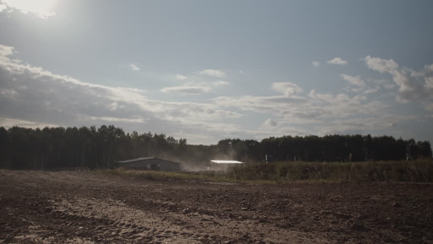 Extreme biker jumps from behind camera on dusty rural road