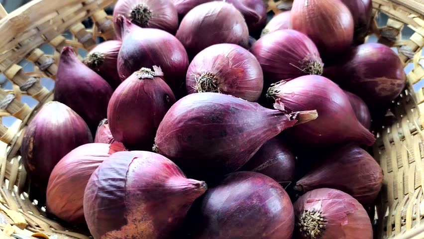 Pile of red onion in the basket , indoor Chiangmai Thailand.