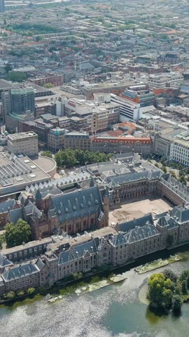 Vertical video. The Hague, Netherlands. Binnenhof. Hofvijver lake in the historical city center. Cloudy weather. Summer day, Aerial View, Point of interest