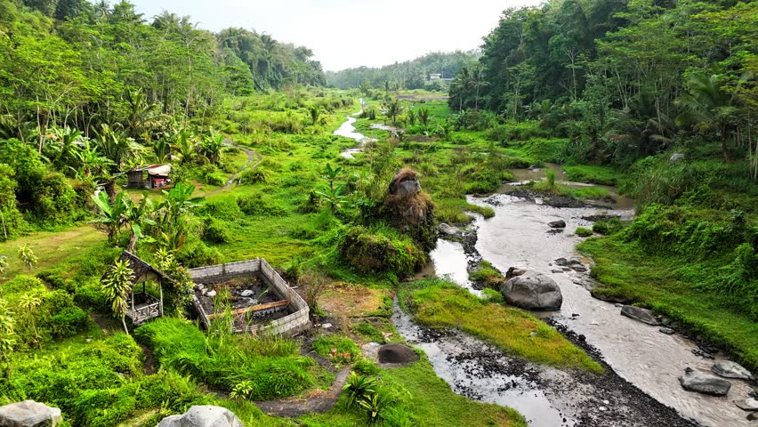 A stunning collection of aerial landscapes from Sleman Yogyakarta Indonesia, showcasing lush green valleys, winding rivers, tiered waterfalls, dense tropical forests and rural villages.