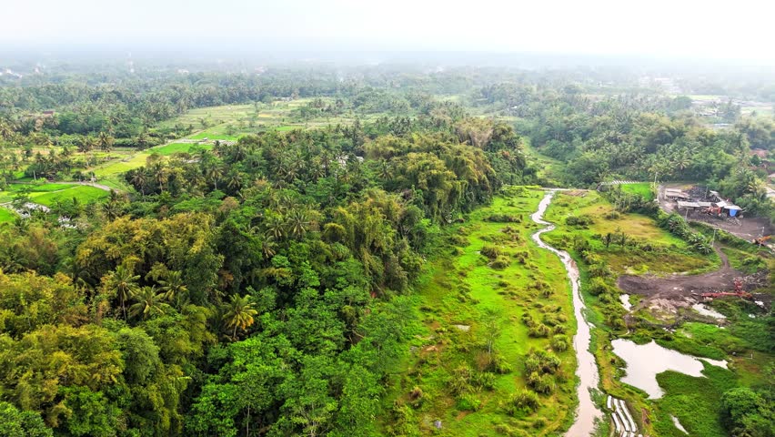A stunning collection of aerial landscapes from Sleman Yogyakarta Indonesia, showcasing lush green valleys, winding rivers, tiered waterfalls, dense tropical forests and rural villages.