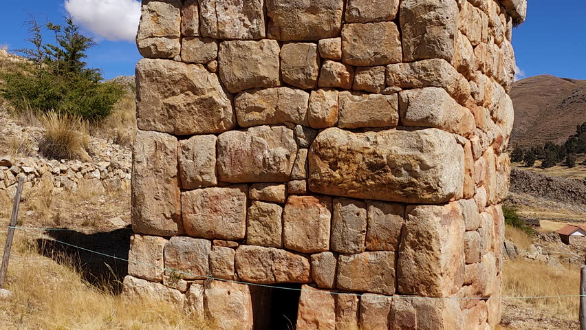 A stunning panoramic view of the ancient stone funerary monuments of Chullpas de Molloco near Acora, Peru, highlighting their historical significance in the Andean landscape.