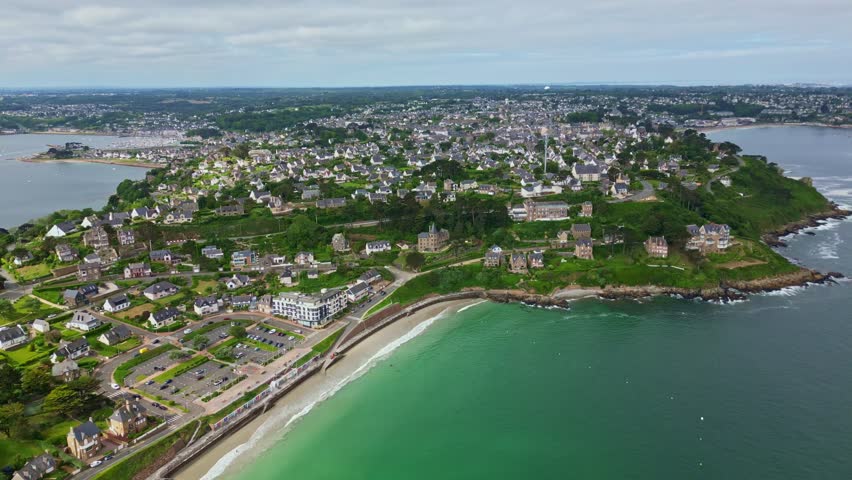 Perros-Guirec coastal town, Pointe du Chateau headland, Plage de Trestignel beach, Brittany, France. Aerial backward