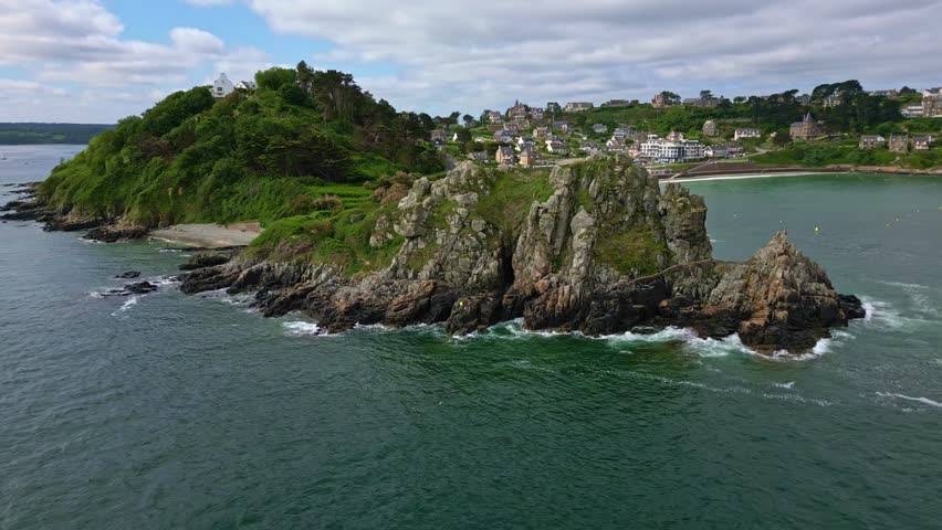 Pointe du Chateau rocky headland and Perros-Guirec coastal town, Brittany, France. Aerial drone backward, copy space