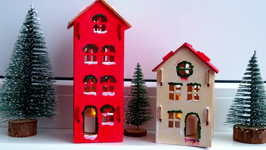 Sustainableminded Christmas cozy atmospheric festive decor in modern scandinavian home handmade decoration. Craft wooden houses. Seasonal activity for kids. Christmas