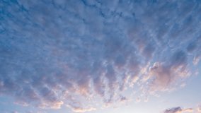Looped time-lapse of sunset sky with moving clouds in warm evening light - Powered by Shutterstock - Get 15% off with code: PIKWIZARD15