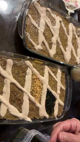 Roasted eggplant dip Kashke Bademjan Persian side dish is a traditional homemade fermented yogurt garnish grilled slices healthy vegetarian buffet family in dining indoor feast Iranian cuisine party