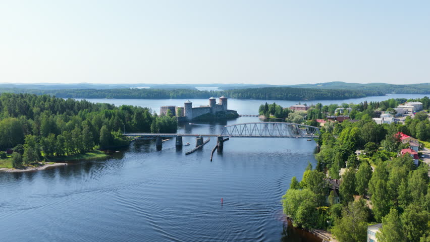 Establishing drone shot approaching the Olavinlinna fort, summer in Savo, Finland