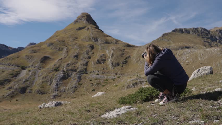 Female photographer takes photos of the scenic peaks in Durmitor National Park