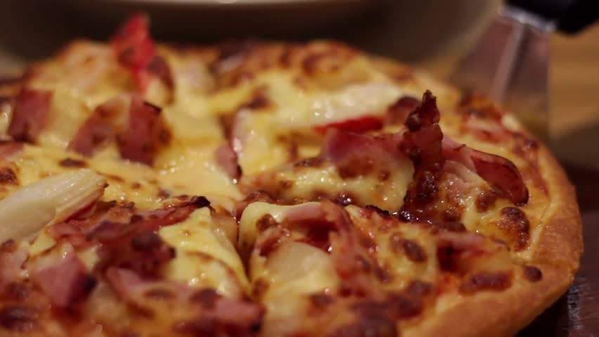 Pizza in a box on the table. Dolly slider extreme close-up. Home party. Top view male female hands taking slices of pizza food delivery open box.