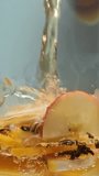 Hot water pours over black tea with apple, ginger and lemon, brewing vitamin rich infusion in clear glass, close-up shot. - Powered by Shutterstock - Get 15% off with code: PIKWIZARD15