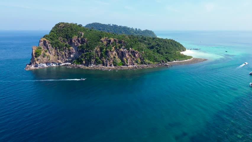 Beautiful tropical islands of Koh Rok in the south of Thailand. Green islands with cliffs, turquoise water near the shore and white beaches.