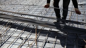 Worker placing steel reinforcement bars at construction site - Powered by Shutterstock - Get 15% off with code: PIKWIZARD15