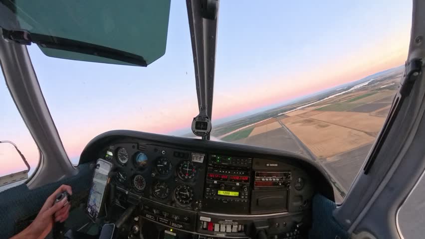Golden hour flight in a general aviation aircraft over Northern California’s fields. Stunning rural terrain meets vibrant skies in this scenic sunset captured from above.