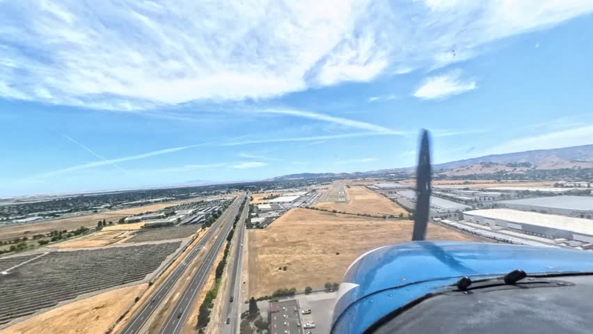 Cessna 172 on final approach and landing in Vacaville, California. Smooth descent over fields and runway touchdown captured in clear daylight from cockpit or exterior perspective.