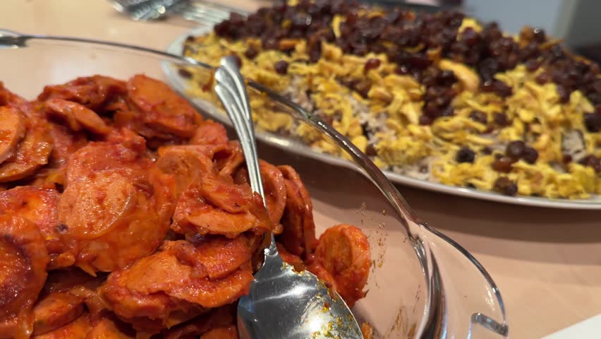 Persian party buffet with sosis bandari adas polo sandwich cake and creamy kashke bademjan side dish Handmade dishes featuring roasted eggplant garlic tangy yogurt and traditional flavors in Tehran