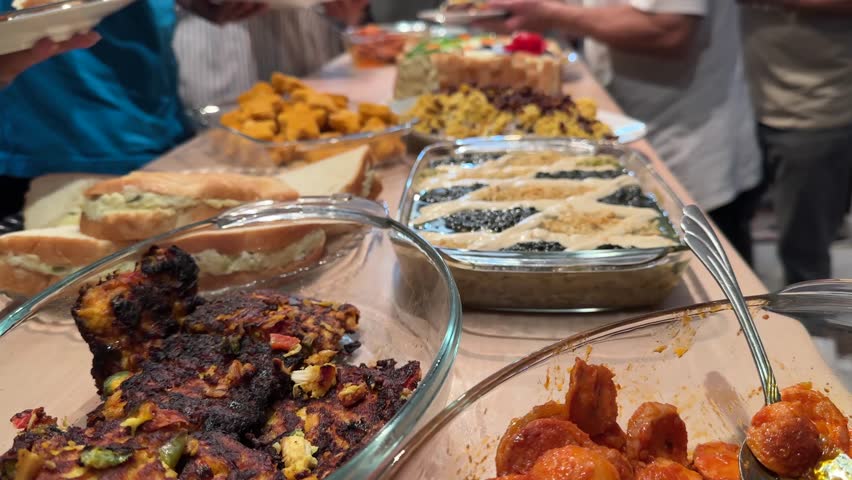 Persian party feast roasted eggplant kashke bademjan grilled sausages traditional stews and fresh vegetables Served buffet-style indoors for family gatherings with hot healthy meals sausage platter