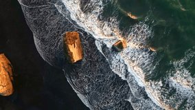 Aerial view of waves crashing against the black sandy shore and rocky outcrops, creating a stunning contrast of dark and light, Tongaporutu, Taranaki Region, New Zealand. - Powered by Shutterstock - Get 15% off with code: PIKWIZARD15