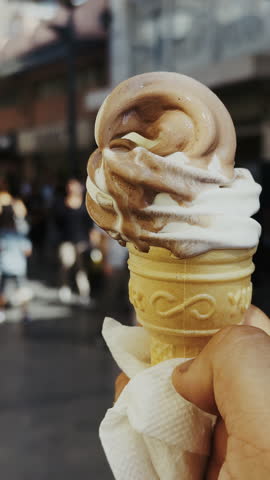 Holding a Delicious Ice Cream Cone on a Crowded Street