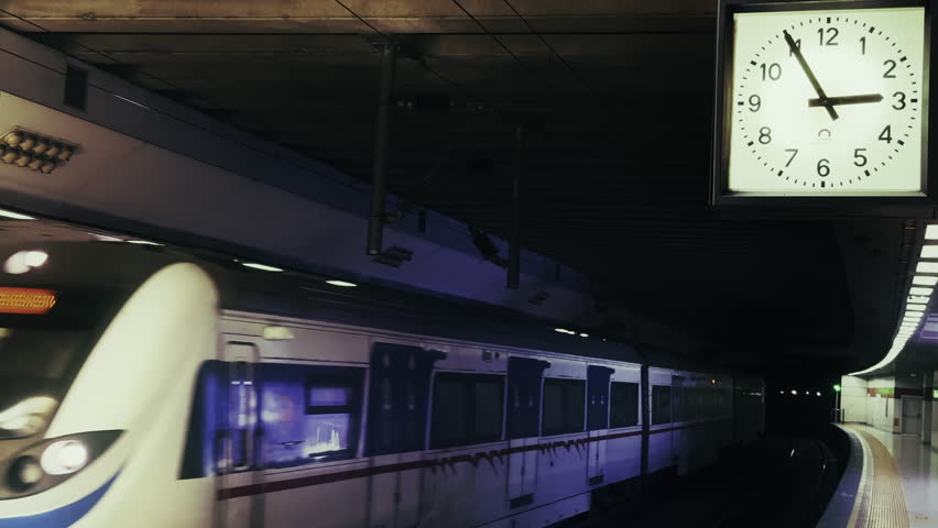 Moving Subway Train in Metro Station and Big Clock