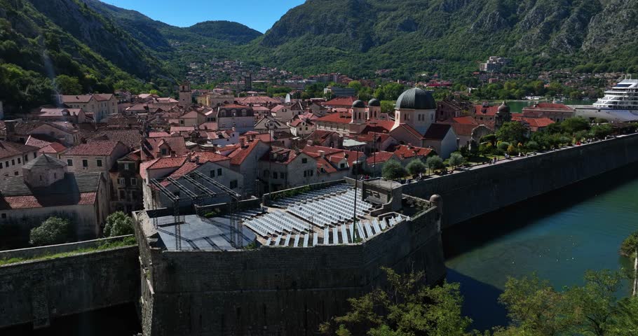 Aerial: fortifications of Kotor during the day in Montenegro, orbit drone shot