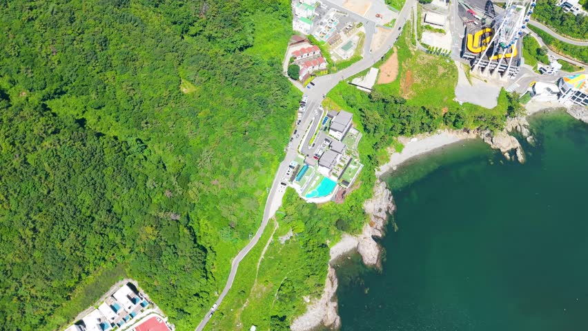 Aerial view of Yeosu Art Land in Dolsan, South Korea, featuring a Ferris wheel, resorts, and scenic southern coast