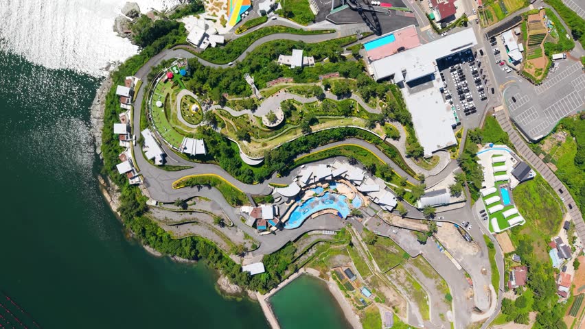 Aerial view of Yeosu Art Land in Dolsan, South Korea, featuring a Ferris wheel, resorts, and scenic southern coast