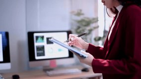Businesswoman is standing and using a digital tablet to present marketing data - Powered by Shutterstock - Get 15% off with code: PIKWIZARD15