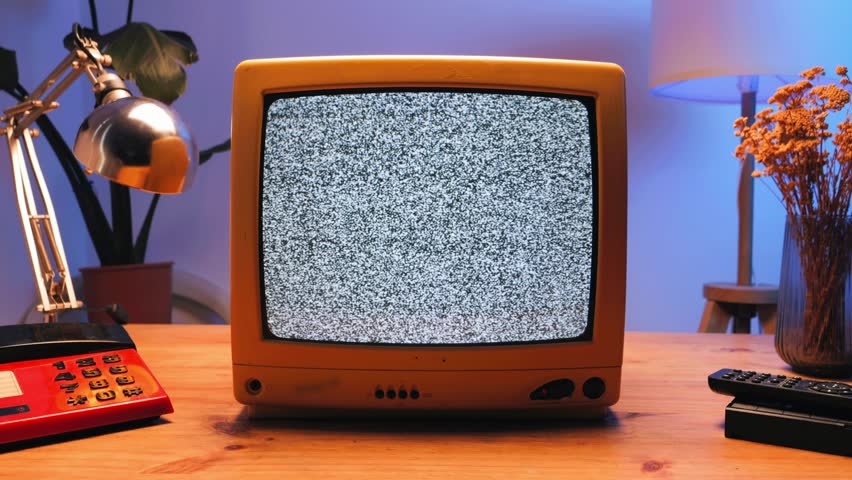 Retro TV, vintage television In a nostalgic setup, a retro TV displays grain on screen, scary halloween night device good for chroma key and green screen.
