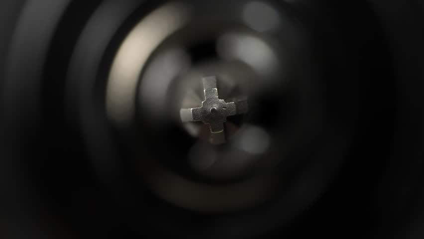 Chuck for cordless screwdriver with bit for unscrewing or screwing screws on black background, close up. Nozzle for screwdriver, attachment bit, macro, rotates