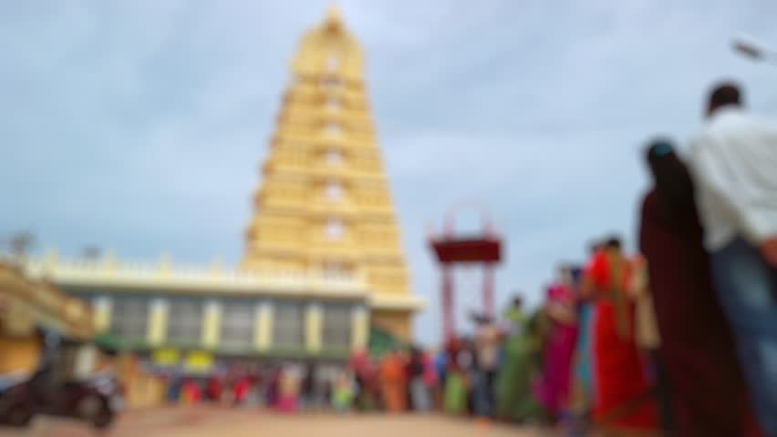 Bokeh view of devotees visit Sri Chamundeshwari Temple, located on Chamundi Hills near Mysore, India. Blurred background footage.