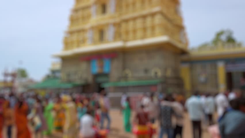 Bokeh view of devotees visit Sri Chamundeshwari Temple, located on Chamundi Hills near Mysore, India. Blurred background footage.