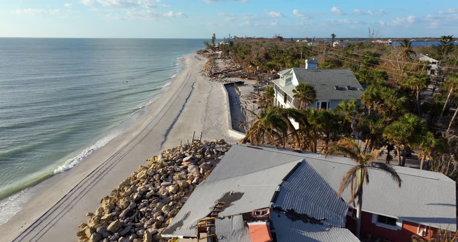 Storm surge caused by hurricane wind severe damaged residential houses on ocean shore. Natural disaster consequences in Florida.